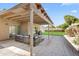 Relaxing covered patio with comfortable seating area, stone tile, and view of the landscaped backyard at 6819 N 10Th Pl, Phoenix, AZ 85014