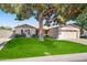 Charming single-story home with a well-manicured lawn and mature tree offering shade at 6819 N 10Th Pl, Phoenix, AZ 85014