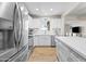 Bright kitchen features white cabinets, stainless steel appliances, quartz countertops, and wood-look floors at 6819 N 10Th Pl, Phoenix, AZ 85014