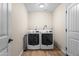 Practical laundry room showcasing modern washer and dryer units, complemented by wood-look flooring at 6819 N 10Th Pl, Phoenix, AZ 85014