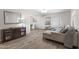 Bright living room featuring wood floors, neutral decor, and seamless flow into dining area at 6819 N 10Th Pl, Phoenix, AZ 85014