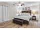 Cozy main bedroom with wood-look floors, a ceiling fan, and elegant furnishings at 6819 N 10Th Pl, Phoenix, AZ 85014