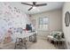 Inviting office with floral accent wall, white desk, comfortable chair and bright window with shutters at 6819 N 10Th Pl, Phoenix, AZ 85014