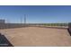 Spacious dirt backyard enclosed by block wall and iron fence, offering a blank canvas for landscaping at 7944 W Griswold Rd, Peoria, AZ 85345