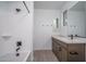 Well lit bathroom with a shower-tub and modern vanity featuring stone countertops at 7944 W Griswold Rd, Peoria, AZ 85345