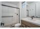 Modern bathroom features a sleek glass shower, and stylish vanity with stone countertops at 7944 W Griswold Rd, Peoria, AZ 85345