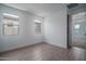 Wood look floor, white walls, and several windows at 7944 W Griswold Rd, Peoria, AZ 85345