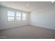Spacious bedroom with carpet, recessed lighting, and multiple windows at 7944 W Griswold Rd, Peoria, AZ 85345