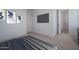 Spacious bedroom with a large TV, soft carpet, and neutral wall colors at 7944 W Griswold Rd, Peoria, AZ 85345