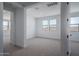 Well-lit bedroom featuring neutral carpet and ample windows for natural light at 7944 W Griswold Rd, Peoria, AZ 85345