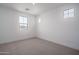 Bright, carpeted bedroom has two windows and fresh white trim at 7944 W Griswold Rd, Peoria, AZ 85345