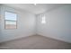 Carpeted bedroom features large windows, baseboards and white trim at 7944 W Griswold Rd, Peoria, AZ 85345