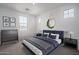 Cozy bedroom featuring a blue bed frame, soft carpet, and plenty of natural light from three windows at 7944 W Griswold Rd, Peoria, AZ 85345