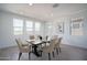 Elegant dining room with large windows and a stylish table setting for six at 7944 W Griswold Rd, Peoria, AZ 85345