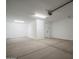 Clean, bright garage with ample space, featuring a modern door opener and smooth concrete flooring at 7944 W Griswold Rd, Peoria, AZ 85345