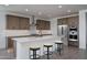Modern kitchen features a large island, stainless steel appliances, and sleek cabinetry at 7944 W Griswold Rd, Peoria, AZ 85345