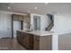 Island kitchen featuring a white counter top with brown cabinets and wood-style floors at 7944 W Griswold Rd, Peoria, AZ 85345