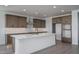 Modern kitchen with sleek white countertops, brown cabinets and stainless steel appliances at 7944 W Griswold Rd, Peoria, AZ 85345