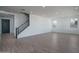 Open-concept living area with modern staircase and wood-style flooring at 7944 W Griswold Rd, Peoria, AZ 85345