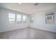 Spacious living room with wood-style floors, large windows, and ample natural light at 7944 W Griswold Rd, Peoria, AZ 85345