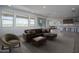 Spacious living room with hardwood floors, a comfortable sectional, and abundant natural light at 7944 W Griswold Rd, Peoria, AZ 85345