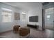 Modern sitting area with chairs, television, and wood flooring at 7944 W Griswold Rd, Peoria, AZ 85345