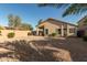 Private backyard featuring a covered patio, desert landscaping, and privacy wall at 80 W Grey Stone St, San Tan Valley, AZ 85143