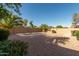 Large private backyard featuring desert landscaping, a privacy wall, and a patio area at 80 W Grey Stone St, San Tan Valley, AZ 85143