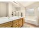 Bright bathroom featuring a double vanity, large mirror, tub, and separate shower stall at 80 W Grey Stone St, San Tan Valley, AZ 85143