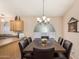 Formal dining area featuring a large table, seating for eight, and decorative light fixtures at 80 W Grey Stone St, San Tan Valley, AZ 85143