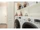 Laundry room with washer, dryer, shelving and a neutral colored wall at 80 W Grey Stone St, San Tan Valley, AZ 85143
