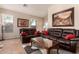 Cozy living room with comfortable leather furniture, decorative art, and lots of natural light at 80 W Grey Stone St, San Tan Valley, AZ 85143