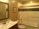 Bathroom featuring a shower-tub combo, framed mirror, white subway tile, and a brown vanity at 8700 E Mountain View Rd # 2029, Scottsdale, AZ 85258