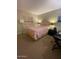 Cozy bedroom featuring a bed, nightstand, desk, neutral walls, and soothing decorative artwork at 8700 E Mountain View Rd # 2029, Scottsdale, AZ 85258