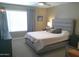 Comfortable bedroom with a large window, grey accents, plush bedding, and contemporary lighting at 8700 E Mountain View Rd # 2029, Scottsdale, AZ 85258