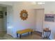 Bright entryway with a sunburst mirror, yellow bench, and neutral decor that creates a welcoming atmosphere at 8700 E Mountain View Rd # 2029, Scottsdale, AZ 85258