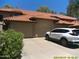 Two-car garage with neutral doors and a white SUV parked in the driveway, offering ample parking at 8700 E Mountain View Rd # 2029, Scottsdale, AZ 85258