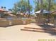 Outdoor grill area with built-in grills, a dining table, and seating for community gatherings at 8700 E Mountain View Rd # 2029, Scottsdale, AZ 85258