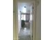 Hallway with tile flooring and a glimpse into a bedroom with natural light and soft colors at 8700 E Mountain View Rd # 2029, Scottsdale, AZ 85258