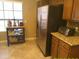 Kitchen features stainless steel refrigerator and appliances, tile flooring, plus additional dining and workspace at 8700 E Mountain View Rd # 2029, Scottsdale, AZ 85258