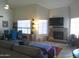 Spacious living room with a fireplace, comfortable seating, and an open layout to the dining area at 8700 E Mountain View Rd # 2029, Scottsdale, AZ 85258