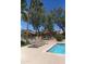 Serene community pool with comfortable lounge chairs and mature trees, offering a relaxing environment at 8700 E Mountain View Rd # 2029, Scottsdale, AZ 85258