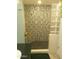 Tiled walk-in shower with mosaic accents, glass block feature, and convenient built-in bench at 8700 E Mountain View Rd # 2029, Scottsdale, AZ 85258