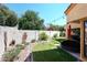 Picturesque backyard featuring mature landscaping, decorative accents, and a well-maintained green lawn at 9115 N 101St Way, Scottsdale, AZ 85258