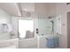 Walk-in shower in modern bathroom with frameless glass, rain shower head, and white subway tile surround at 9115 N 101St Way, Scottsdale, AZ 85258