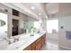 Bathroom featuring dual sinks, large mirror, soaking tub, glass enclosed shower, and tiled floor at 9115 N 101St Way, Scottsdale, AZ 85258