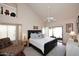 Spacious primary bedroom with vaulted ceiling, ceiling fan, en suite, and access to private patio at 9115 N 101St Way, Scottsdale, AZ 85258