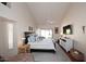 Bright primary bedroom features vaulted ceiling, fan, patio access, and sitting area with a view at 9115 N 101St Way, Scottsdale, AZ 85258
