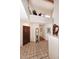 Grand foyer with tile flooring, a high ceiling and beautiful wood door, and a gallery at 9115 N 101St Way, Scottsdale, AZ 85258