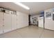 Well-organized garage with built-in cabinets and plenty of storage for tools, equipment, and vehicles at 9115 N 101St Way, Scottsdale, AZ 85258